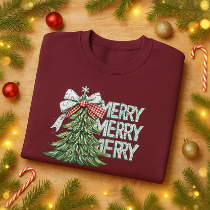 Maroon sweatshirt with Christmas tree design and 'Merry Merry Merry' text on a wooden surface with festive decorations.