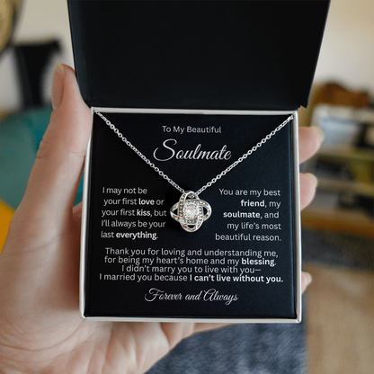 White gold love knot necklace in a white gift box with a heartfelt “To My Beautiful Soulmate” message card, held in a woman's hand.